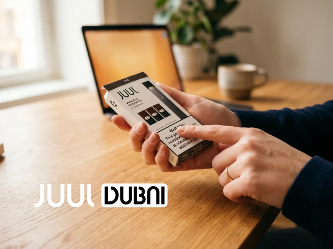 Authentic vs. Fake JUUL Pods packaging and batch code inspection being checked carefully on a desk in the UAE